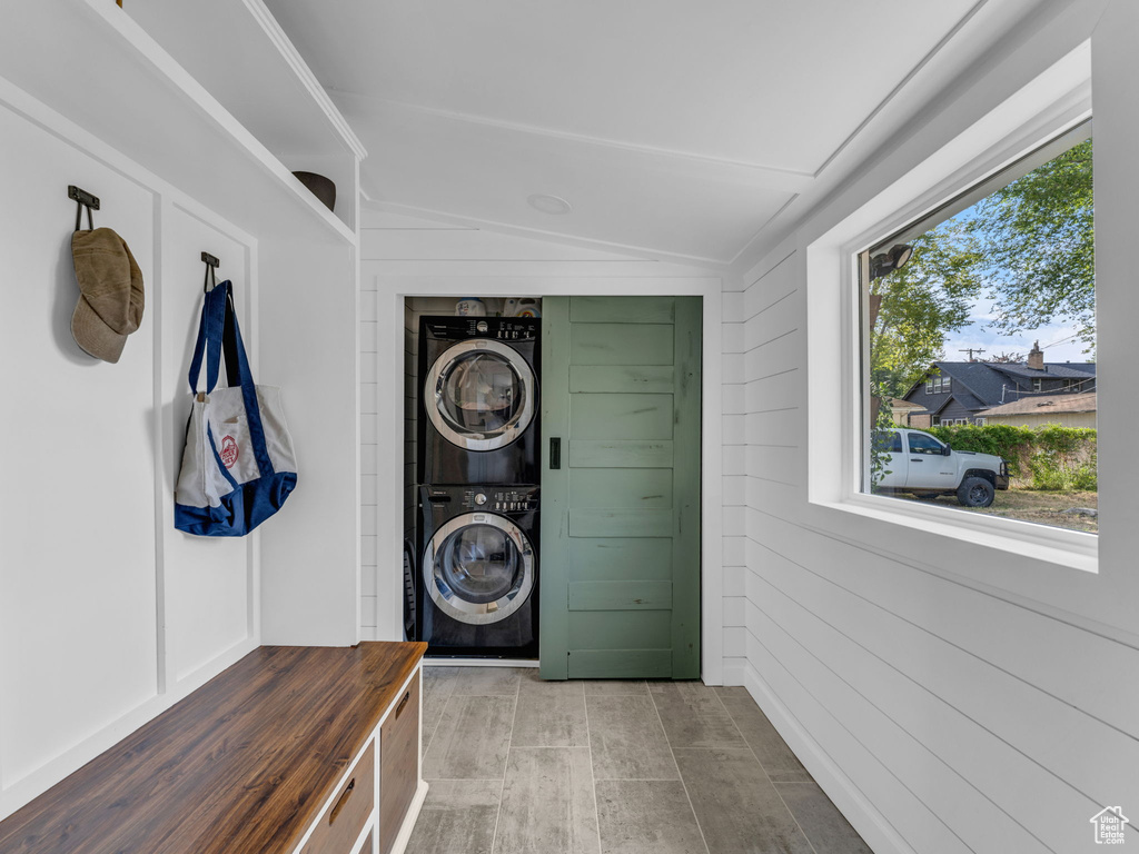 Laundry area featuring estacked washer and dryer and wood finished floors