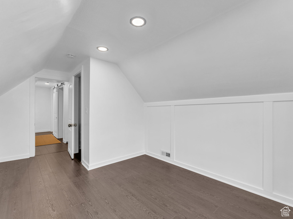 Bonus room with dark wood-type flooring, vaulted ceiling, and recessed lighting