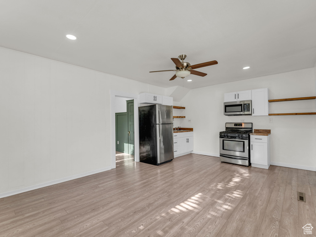 Kitchen with stainless steel appliances, open shelves, a ceiling fan, white cabinetry, and recessed lighting