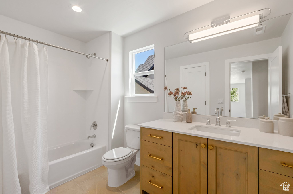 Full bathroom featuring vanity, shower / bath combo, and tile patterned flooring