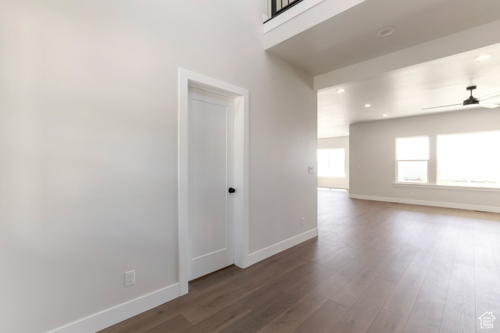 Empty room featuring baseboards, a ceiling fan, recessed lighting, and dark wood finished floors