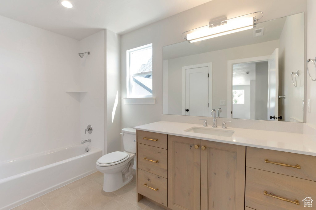 Full bathroom featuring toilet, tile patterned floors, vanity, and shower / bathtub combination