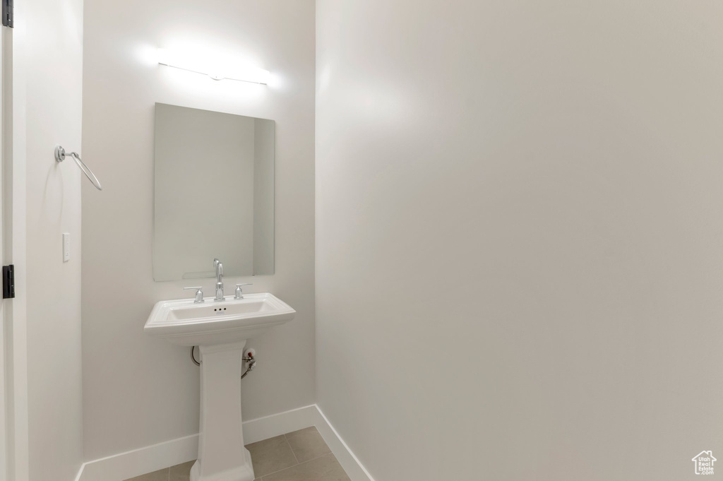 Bathroom featuring tile patterned floors and baseboards