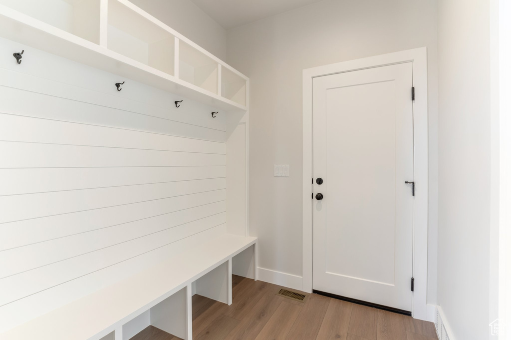 Mudroom with light wood-style floors and baseboards