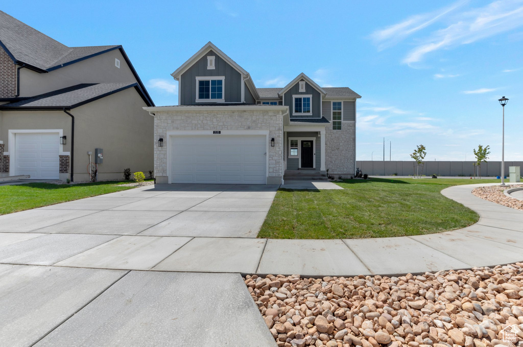 View of front of property with driveway and an attached garage
