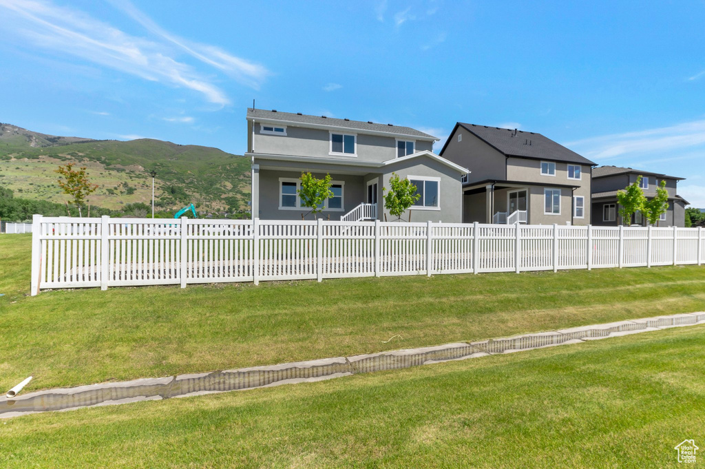 Back of house featuring stucco siding and a mountain view