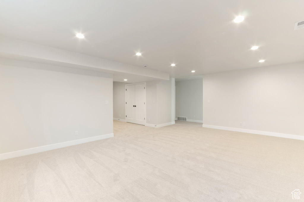 Finished basement featuring recessed lighting, baseboards, and light carpet