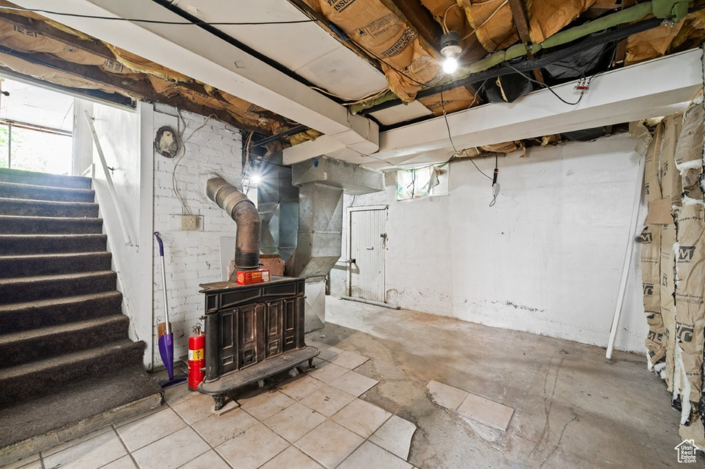 Below grade area with a wood stove and stairs