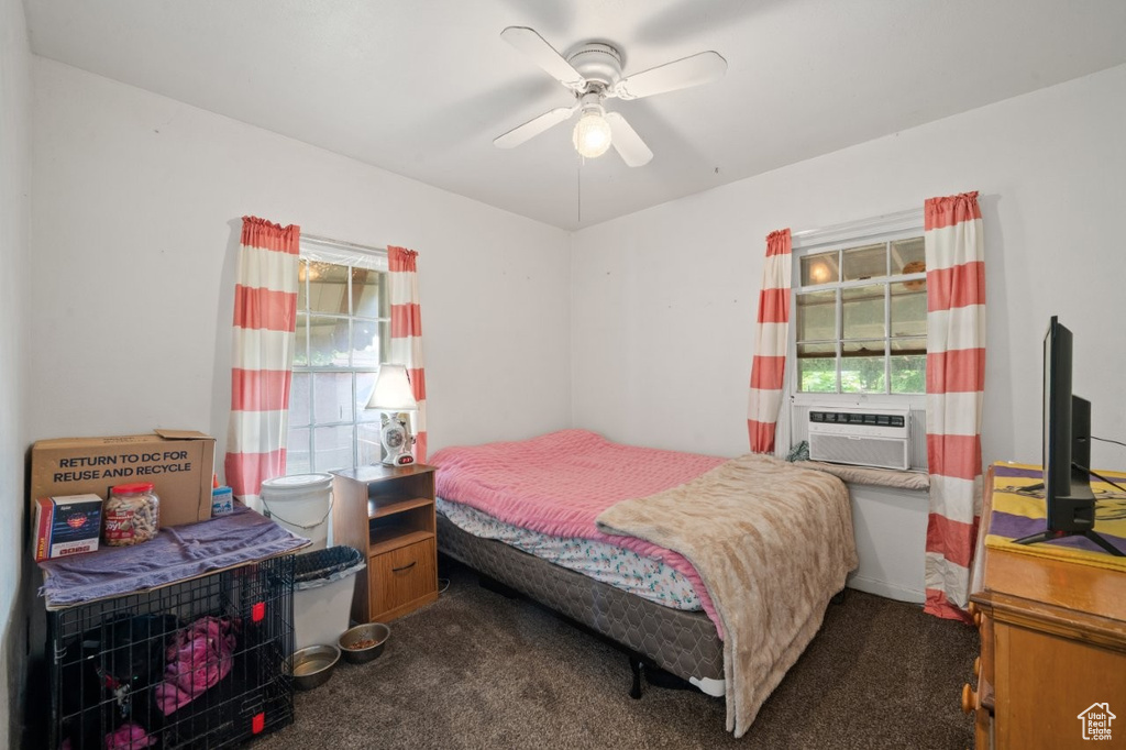 Carpeted bedroom featuring cooling unit and ceiling fan