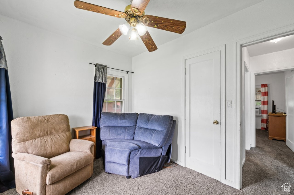 Sitting room featuring carpet floors and a ceiling fan