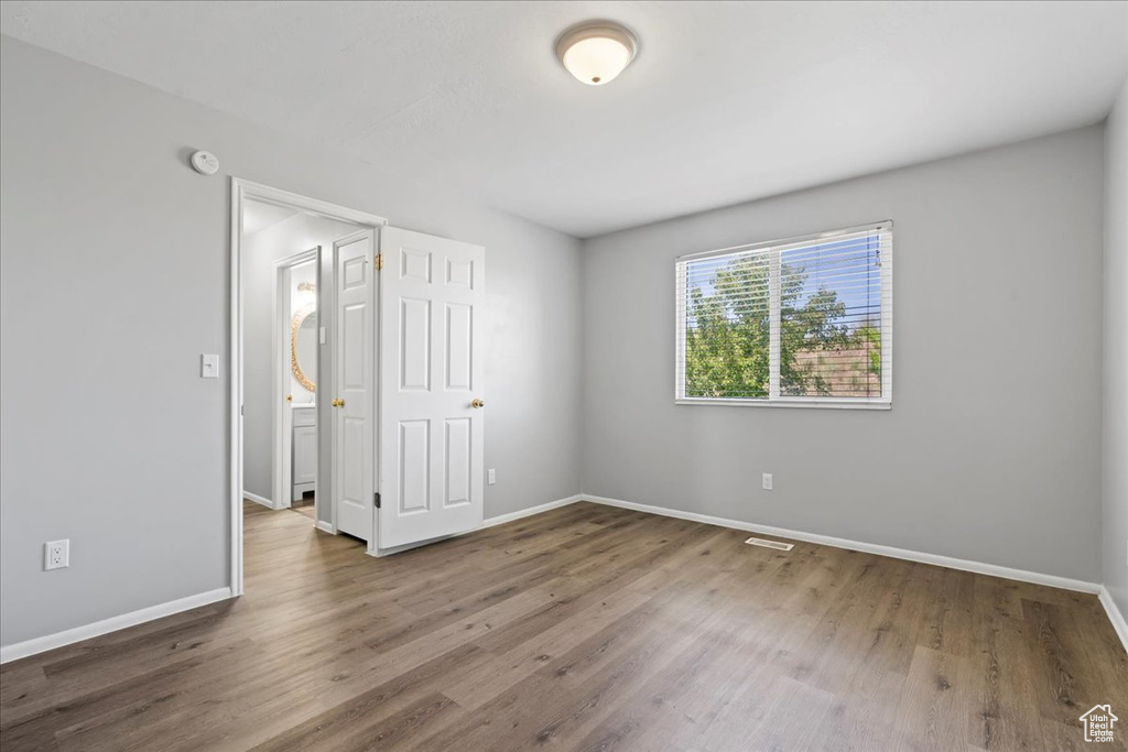 Unfurnished bedroom featuring baseboards and wood finished floors