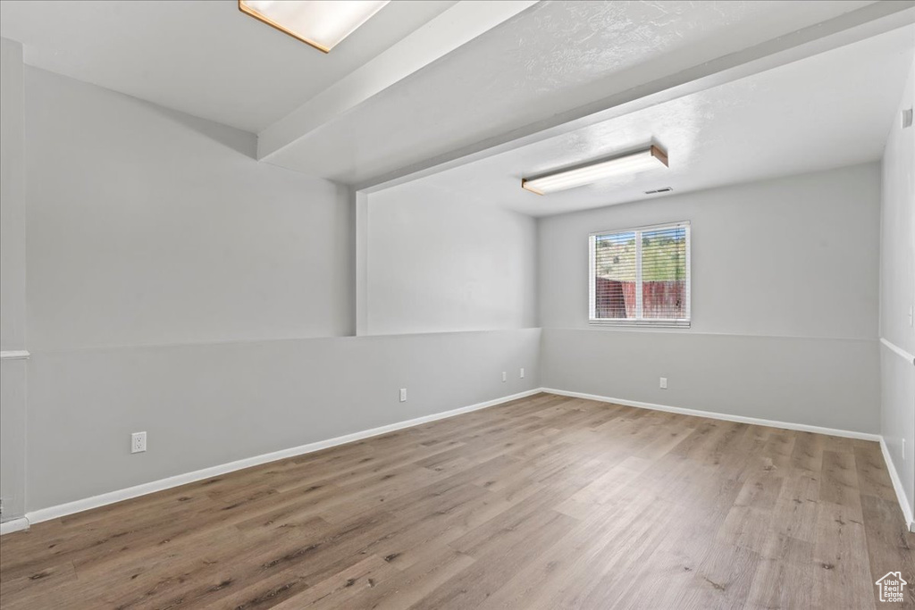 Unfurnished room featuring wood finished floors and baseboards