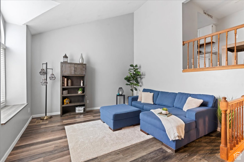 Living room featuring wood finished floors, baseboards, and healthy amount of natural light