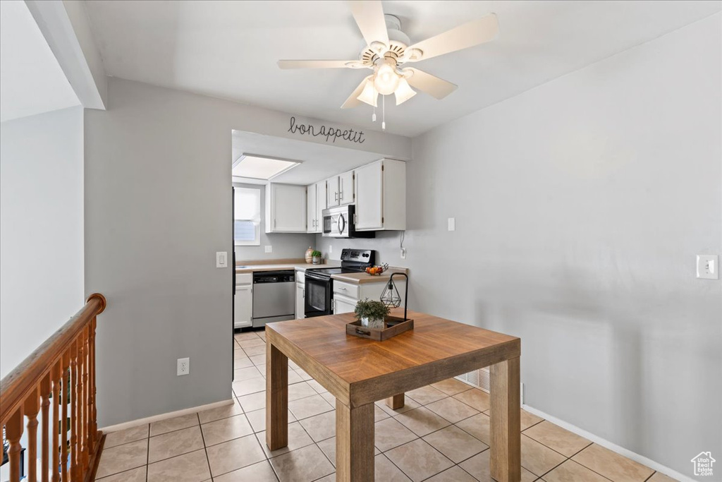 Kitchen featuring appliances with stainless steel finishes, white cabinets, ceiling fan, light countertops, and light tile patterned floors