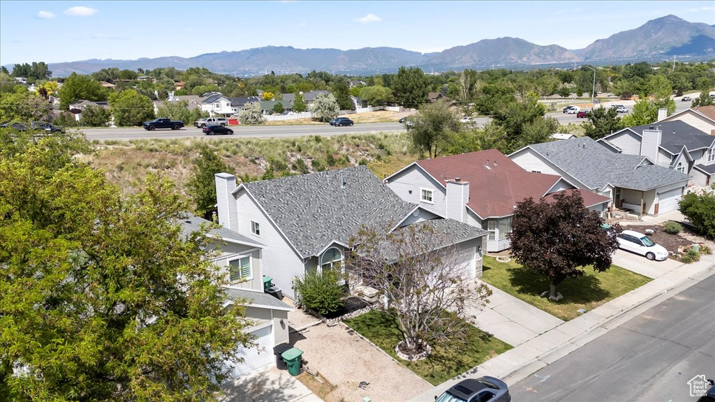 Aerial view of residential area featuring a mountainous background