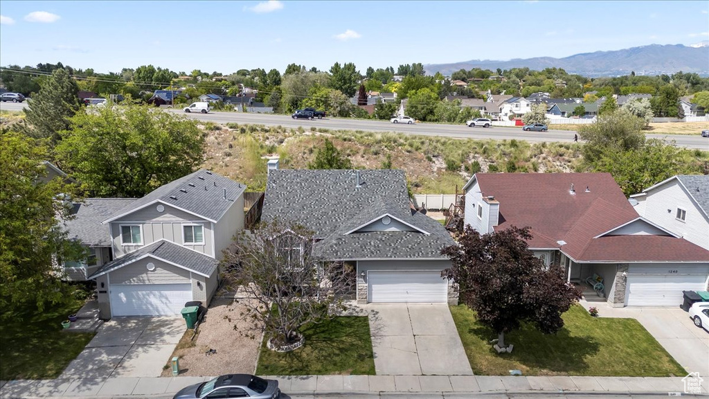 Aerial perspective of suburban area featuring a mountainous background