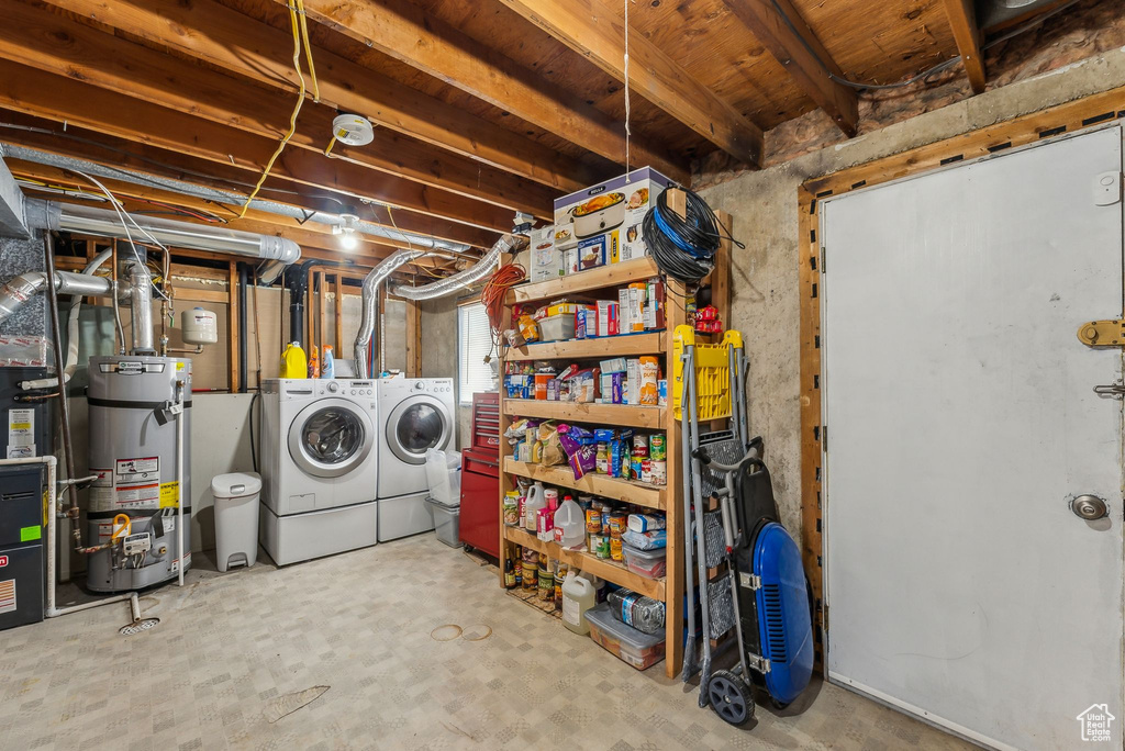 Basement featuring secured water heater and washing machine and dryer