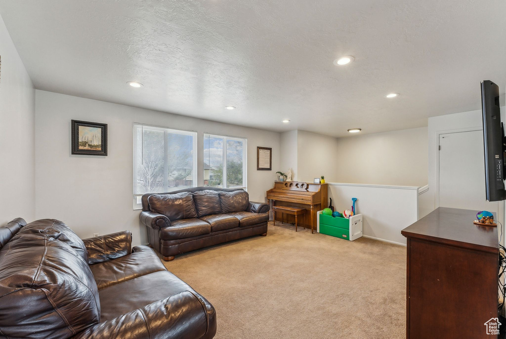 Carpeted living area featuring recessed lighting