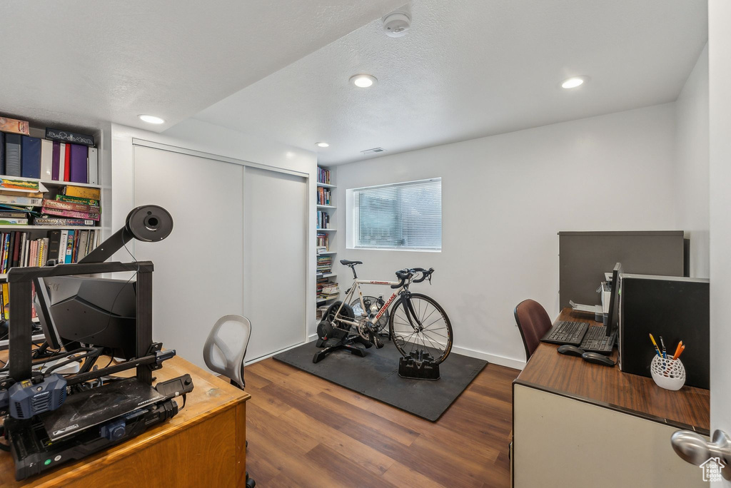 Office featuring wood finished floors and recessed lighting