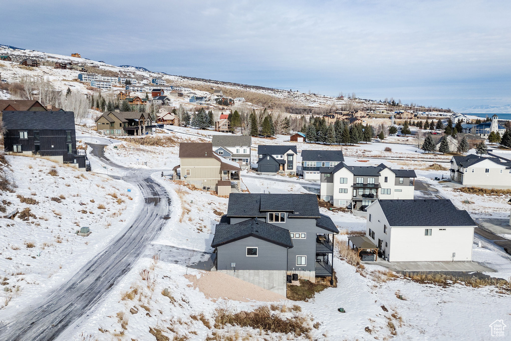 Snowy aerial view featuring a residential view