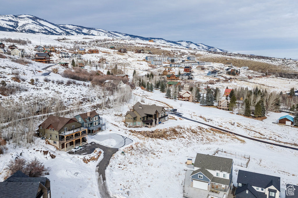 Snowy aerial view with a residential view and a mountain view