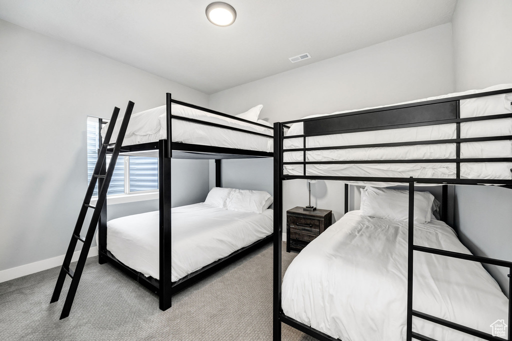 Bedroom with carpet flooring and baseboards