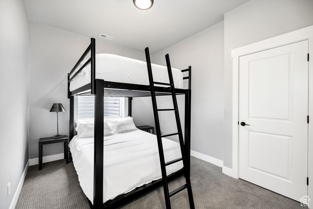 Bedroom featuring carpet floors and baseboards