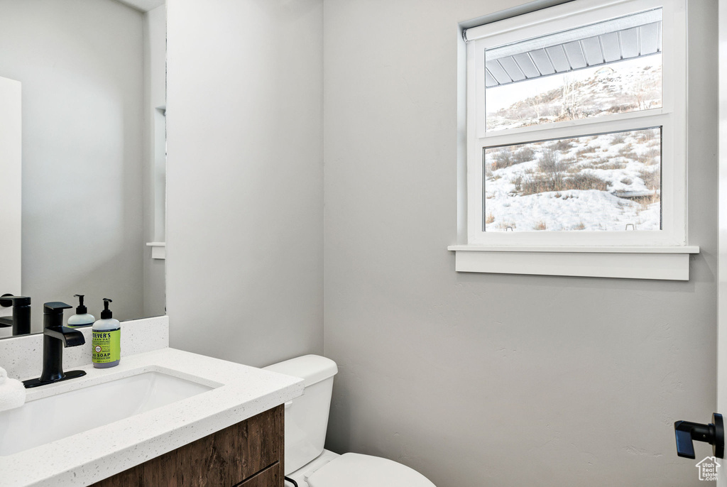 Half bathroom with vanity and toilet