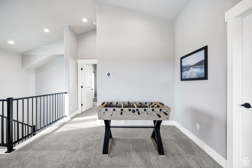Rec room with carpet flooring, lofted ceiling, baseboards, and recessed lighting