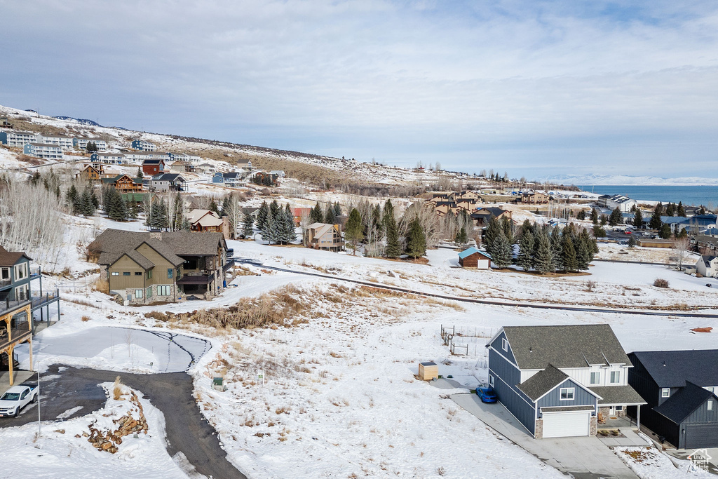 Snowy aerial view featuring a residential view