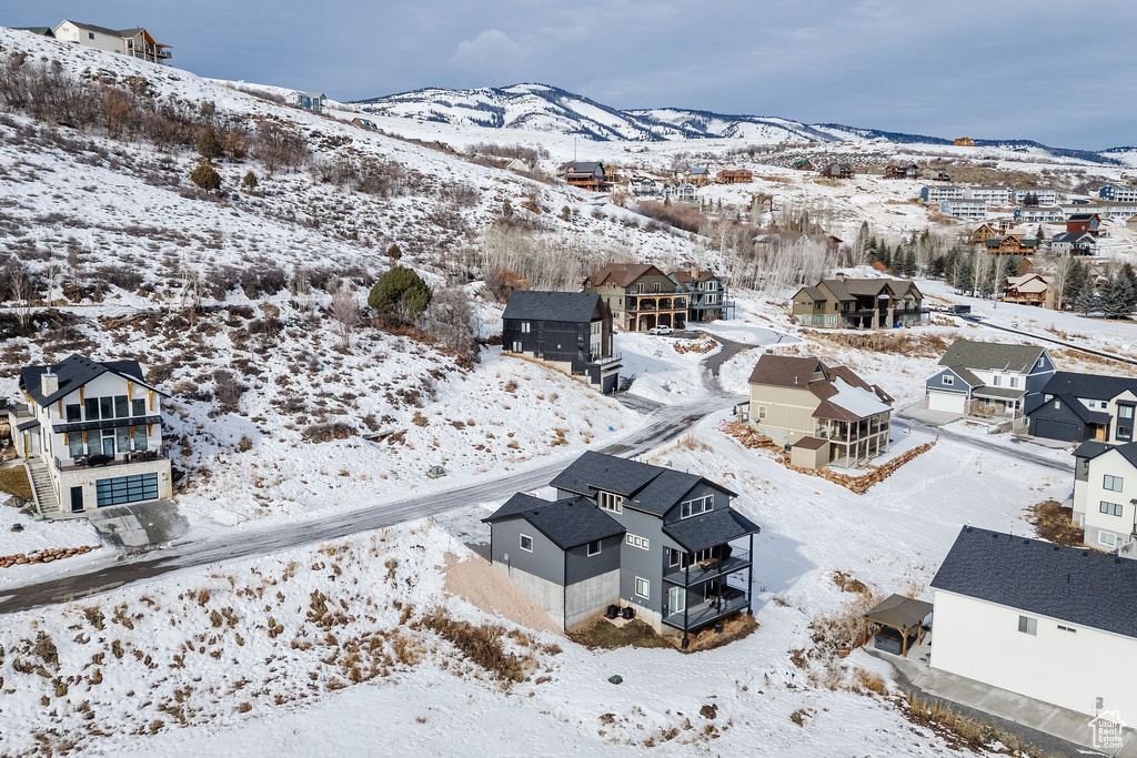 Snowy aerial view with a residential view and a mountain view