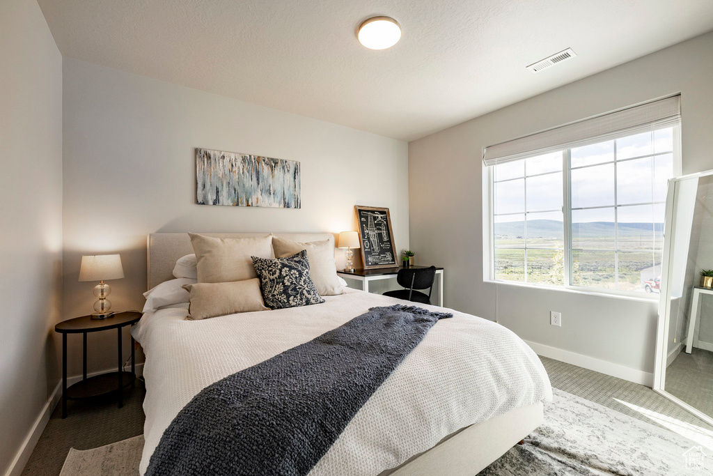 Bedroom featuring carpet flooring and baseboards