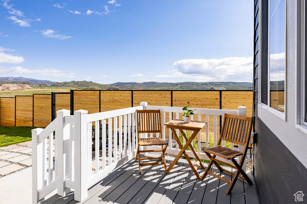 Deck featuring a fenced backyard and a mountain view