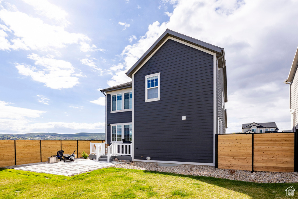 Back of house featuring a patio area and a mountain view