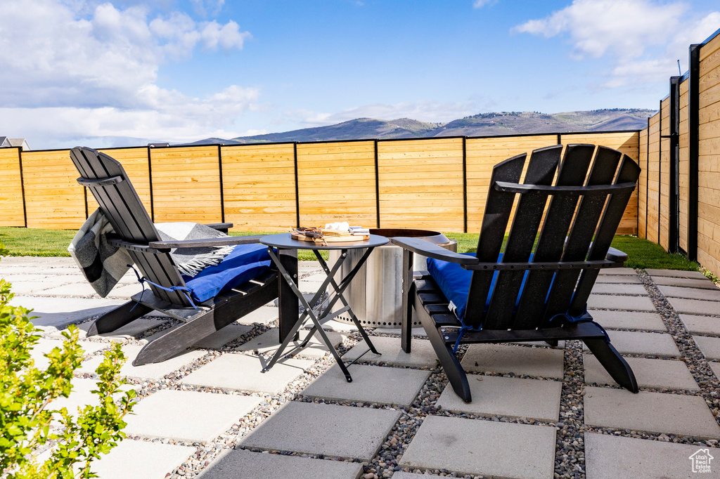 Fenced backyard featuring a patio area and a mountain view