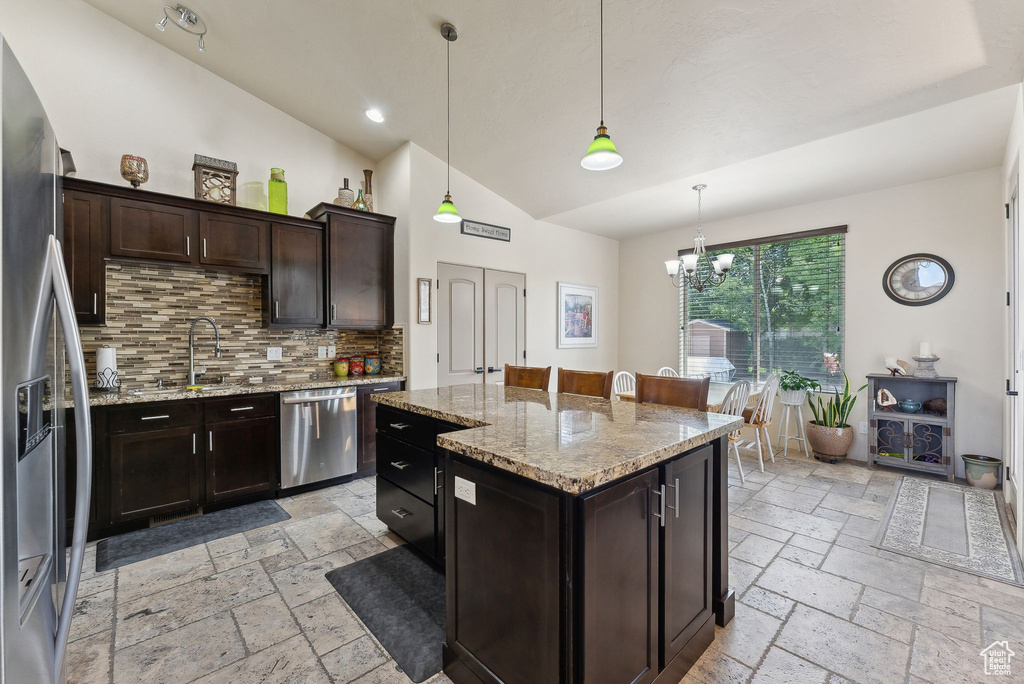 Kitchen featuring appliances with stainless steel finishes, stone tile flooring, tasteful backsplash, a chandelier, and recessed lighting