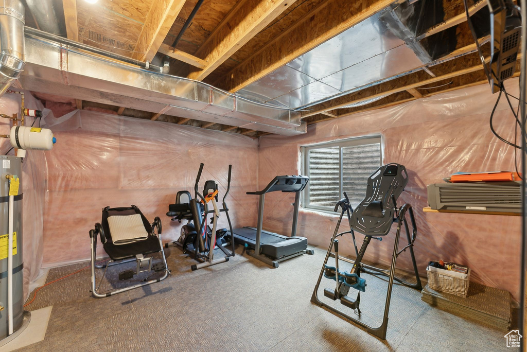 Exercise area with carpet flooring and water heater