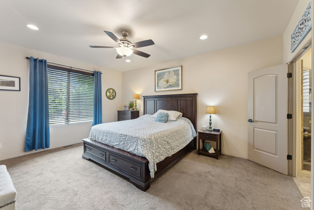 Bedroom featuring light colored carpet, ceiling fan, and recessed lighting
