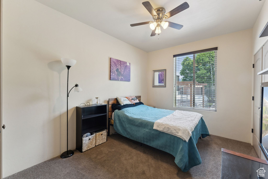 Carpeted bedroom with ceiling fan