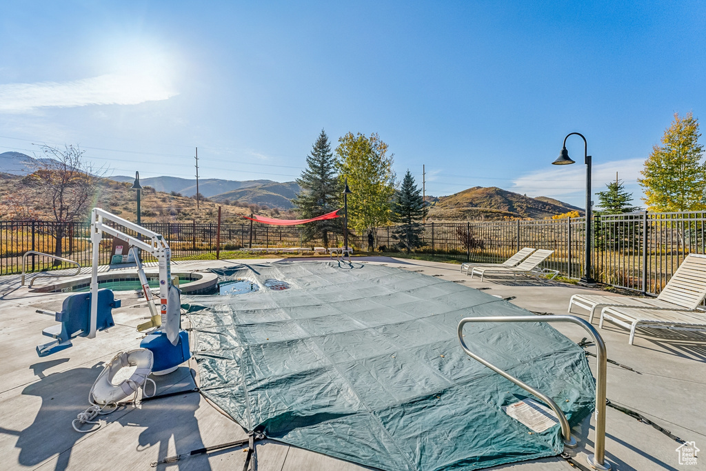 View of pool featuring a fenced backyard, a mountain view, and a patio area