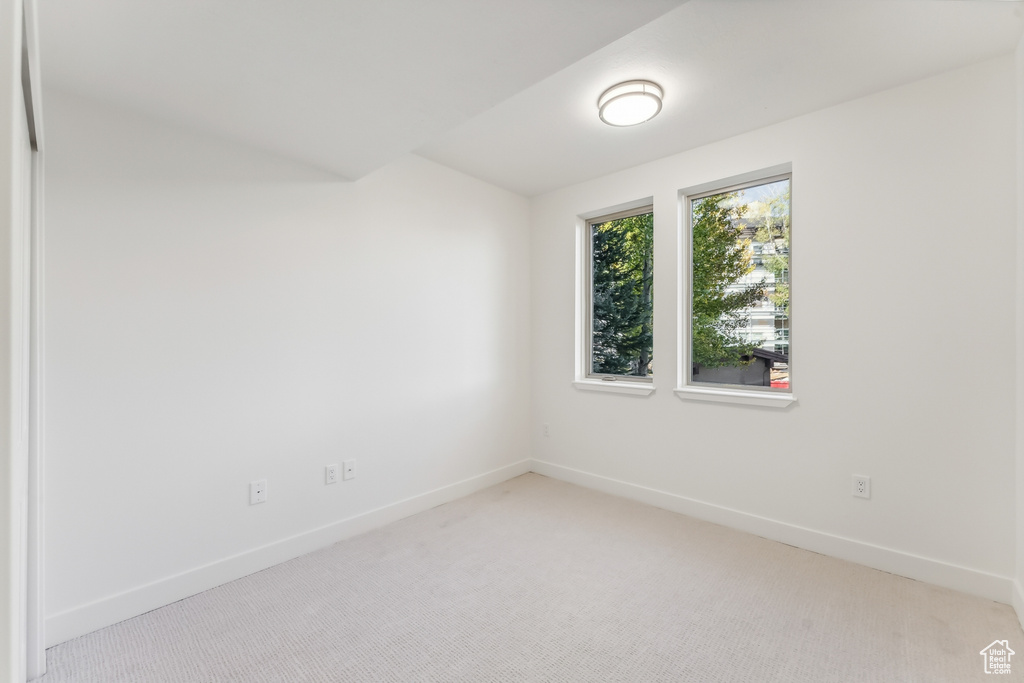 Unfurnished room with carpet and baseboards