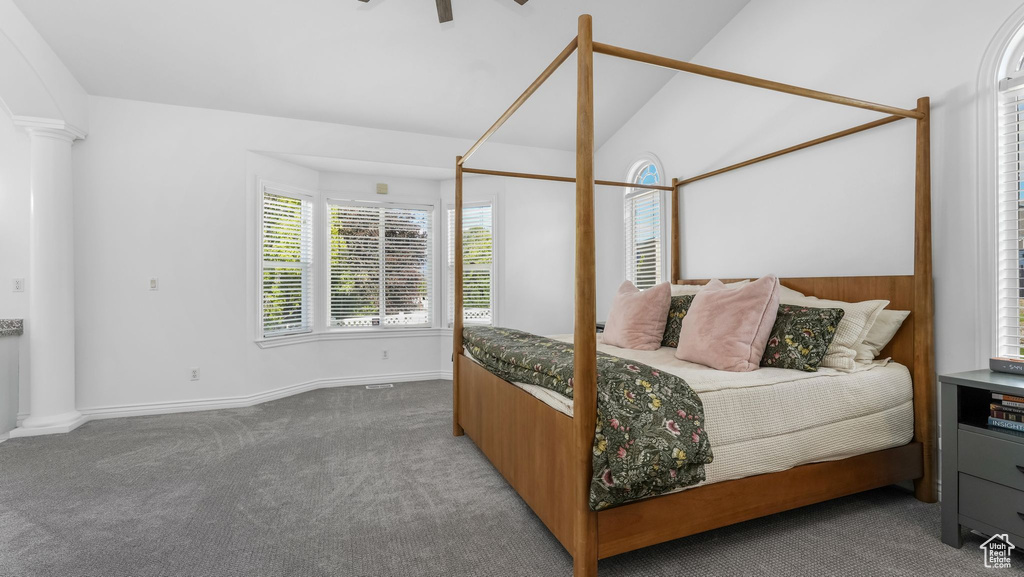 Bedroom with carpet, baseboards, and lofted ceiling