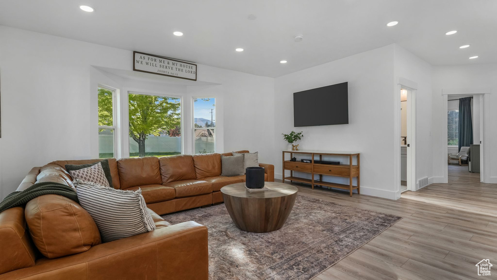 Living area featuring light wood-style flooring, recessed lighting, and baseboards