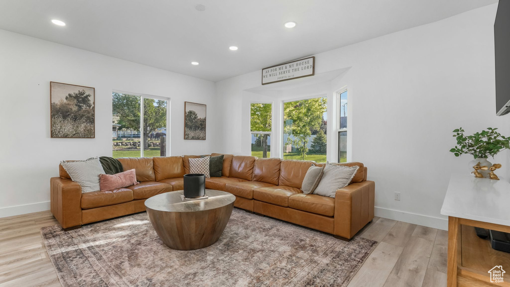 Living area featuring light wood-style floors, recessed lighting, and baseboards