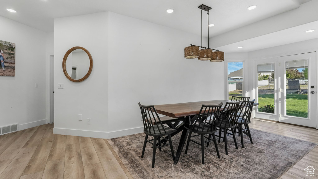 Dining room with light wood-type flooring, recessed lighting, and baseboards