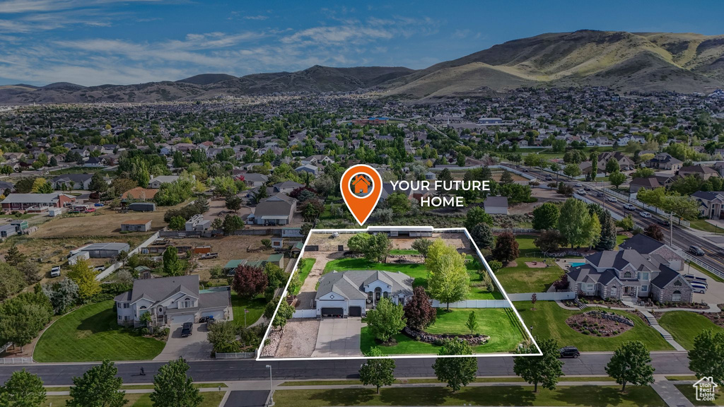 Aerial view of residential area with property boundaries highlighted and mountains