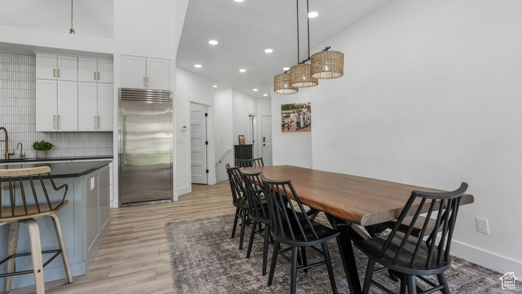 Dining space featuring light wood-style floors, recessed lighting, and baseboards