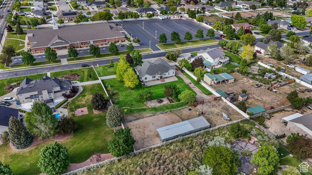 Aerial view of property and surrounding area with nearby suburban area