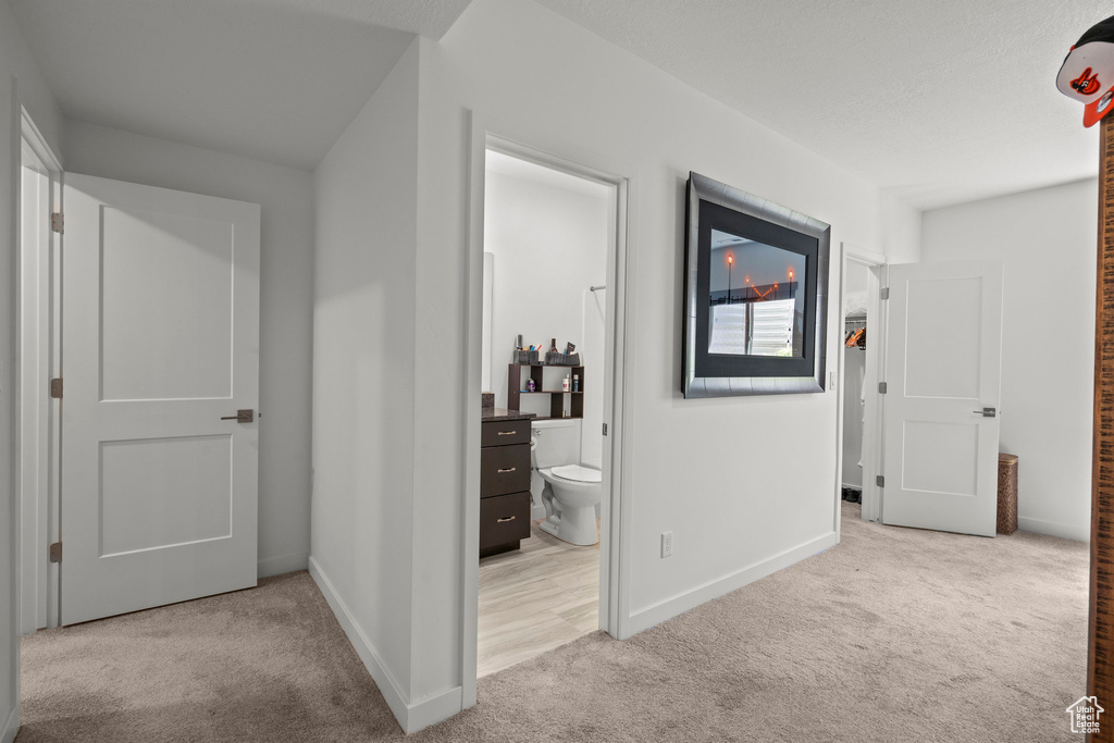 Hall featuring carpet flooring and baseboards