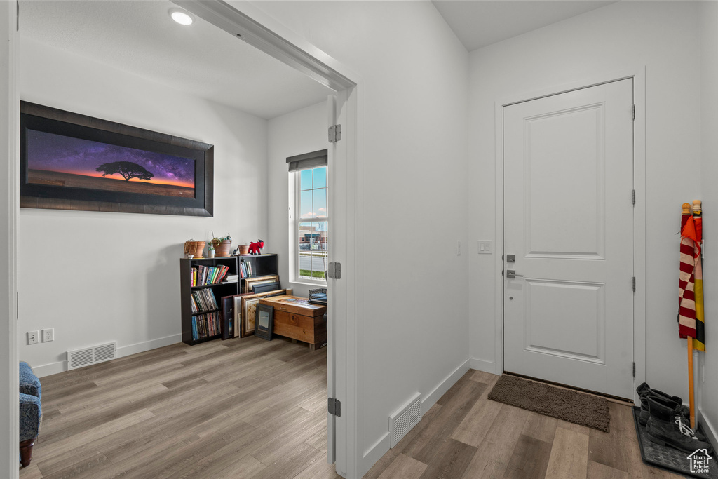 Foyer featuring wood finished floors and baseboards